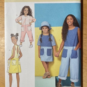 May include: A Butterick sewing pattern featuring illustrations of children's clothing designs. The pattern includes a dress, jumpsuit, and romper, with details like pockets and various sleeve lengths. The pattern number is B6937, and the size range is CCE (3-4-5-6).