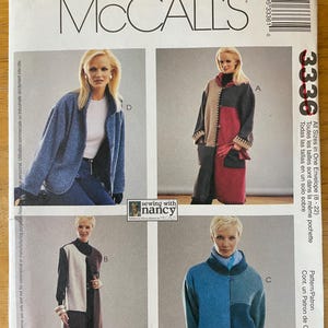 May include: A sewing pattern for three different coats. The first coat is a blue and red color block design. The second coat is a brown and white color block design. The third coat is a blue and gray color block design. The pattern is from McCall's and is called "Sewing with Nancy".