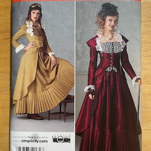May include: Simplicity sewing pattern featuring two Victorian-era costume designs. The pattern includes a long, pleated skirt and a jacket with a high collar. The size range is HH 6, 8, 10, and 12. Sign up for the free newsletter at simplicity.com.