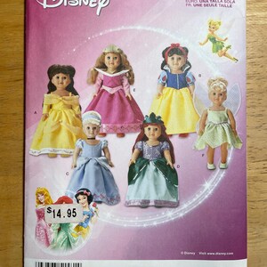 May include: A Simplicity sewing pattern envelope for Disney character doll outfits, numbered 1581. The front displays illustrations of six dolls wearing various costumes, including yellow, pink, blue, and green dresses, with the Disney logo at the top.