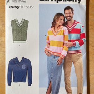 May include: Simplicity sewing pattern R12180 featuring a V-neck sweater design. The pattern includes illustrations of the finished garments, with a couple wearing the sweaters. The text "easy-to-sew" is displayed.
