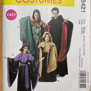 May include: McCall's Costumes sewing pattern M6421. The cover features images of costumes, including a witch, a hooded cloak, and a medieval-style outfit. The pattern is labeled "Easy" and includes sizes for kids.