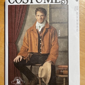 May include: McCall's Costumes sewing pattern featuring a man in a western-style outfit. The pattern includes a brown fringed jacket, a white scarf, and a hat. The text on the pattern reads "COSTUMES" and "Designed and printed in USA."