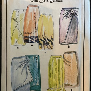 May include: A vintage sewing pattern for six different skirts, titled "in the Studio - 8 with Lois Ericson". The skirts are illustrated in various colors and styles, including a wrap skirt, a pleated skirt, and a skirt with a ruffle.