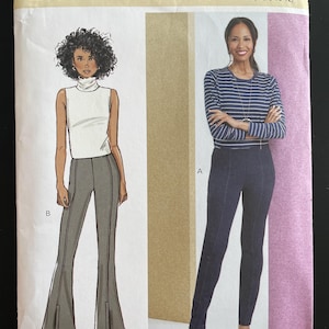 May include: Butterick sewing pattern B6963 featuring illustrations of women's clothing designs. The pattern includes a turtleneck top and flared pants. The size range is D5 (4-6-8-10-12). Designed and printed in the USA.