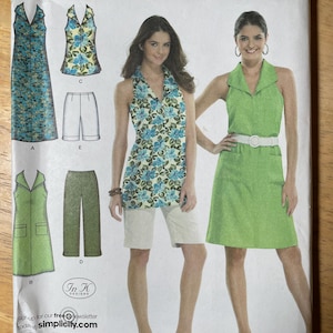 May include: Simplicity easy-to-sew pattern featuring various women's clothing designs. The designs include a dress, top, shorts, pants, and a dress with a collar. The pattern includes sizes 46-54.