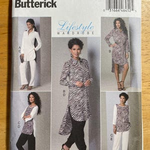 May include: A Butterick sewing pattern envelope, B6294, featuring a Lifestyle Wardrobe. The envelope displays several outfit options, including a white tunic and pants, and a zebra-striped tunic with black pants. The size range is B5 (8-10-12-14-16).