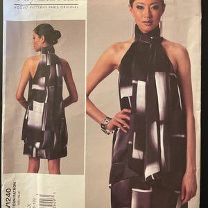May include: A Vogue Patterns sewing pattern by Guy Laroche, featuring a halter dress design. The pattern, V1240, includes sizes AAX (4-6-8-10). The dress is shown in a black and white geometric print, with a high neckline and a short hemline.