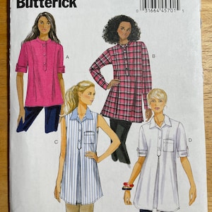 May include: A sewing pattern from Butterick, B6099, featuring four tunic designs. The models are wearing tunics in pink, plaid, striped, and white fabrics. The pattern includes sizes X-small to Medium.