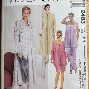 May include: A McCall's Womanstyle sewing pattern, featuring illustrations of women's clothing designs. The pattern includes a long coat, a tunic and skirt set, and a tank top and pants set. The pattern number is 2483.