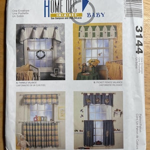 May include: McCall's Home Decor Baby sewing pattern envelope. The front features four window treatment designs: a twinkle valance, picket fence valance, window box valance and cafes, and pocket valance and cafes. The envelope is white with blue and yellow accents.