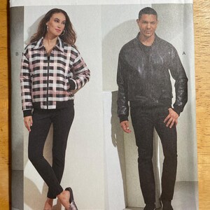 May include: Vogue Patterns sewing pattern V1877. The pattern features two models wearing a jacket and pants. The jacket on the left is a black, white, and pink plaid. The jacket on the right is black. The pattern size is XM (SML-MED-LRG).