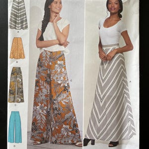 May include: Simplicity sewing pattern S8885 H5. The pattern features several skirt and pant designs, including a striped maxi skirt and wide-leg pants with floral and geometric prints. The size range is U.S. 6-14.