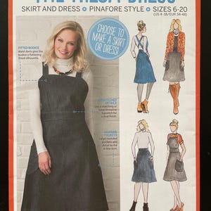 May include: A sewing pattern titled "The Freja Dress" featuring a denim pinafore dress. The pattern includes sizes 6-20 (US 4-18/EUR 34-48). The design includes a fitted bodice, A-line skirt, and large rounded pockets. The pattern is from Simply Sewing.