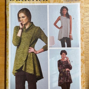 May include: A Butterick sewing pattern envelope featuring three women's garments. The designs include a green wrap top, a striped sleeveless tunic, and a floral print tunic. The pattern number is B6752, with sizes XSM-MED.