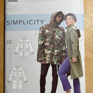 May include: A Simplicity sewing pattern, S9052, featuring a camouflage jacket and a green jacket with a hood. The pattern includes sizes XS-XL. The Mimi G Style logo is at the top.