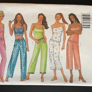 May include: A Butterick sewing pattern featuring illustrations of five pajama sets. The sets include tank tops and wide-leg pants in various colors and patterns, including pink, blue, green, white floral, and peach. The pattern is labeled "FAST & EASY" and includes sizes XS-S-M.