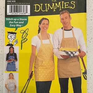 May include: A sewing pattern for aprons, titled "Sewing Patterns for Dummies". The pattern is for one size and includes instructions for making a variety of aprons, including a yellow polka dot apron, a brown apron, and a blue and white floral apron. The pattern also includes instructions for making a matching apron for a man and a woman.