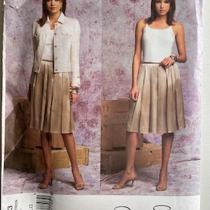 May include: A sewing pattern for a skirt and top by Oscar de la Renta. The pattern is for sizes 8, 10, and 12. The pattern is for a Vogue American Designer.