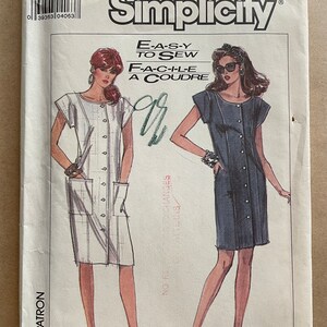 May include: Simplicity sewing pattern 8567. The pattern features illustrations of two button-down dresses. The text "EASY TO SEW" and "FACILE A COUDRE" are displayed. The pattern size is H (6+8+10).
