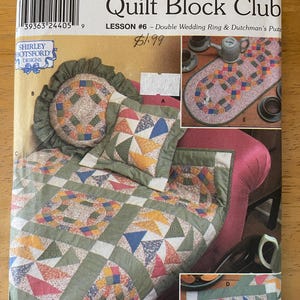 May include: Simplicity Quilt Block Club Lesson #6 pattern featuring a double wedding ring and dutchman's puzzle quilt block design. The pattern includes instructions for making a quilt, pillows, and table runners. The quilt blocks are made with a variety of colorful fabrics, including red, green, blue, and yellow.