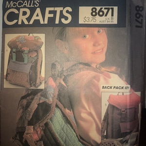 May include: A sewing pattern for a backpack, with a close-up of the finished product. The pattern is McCall's Crafts 8671 and costs $3.75. The backpack is made of brown fabric with a red flap and a brown strap.