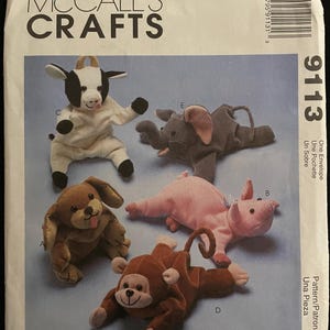 May include: A sewing pattern for five plush toys: a cow, elephant, dog, pig, and monkey. The pattern is from McCall's Crafts and is called "Bambini".
