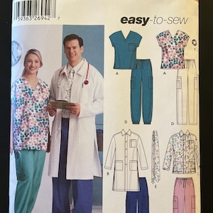May include: Simplicity sewing pattern 5443 for medical scrubs. The pattern includes options for tops, pants, and a lab coat. The scrubs are shown in solid teal, floral, and pink fabrics. The pattern is easy-to-sew.