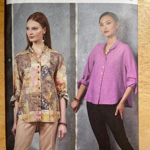 May include: Vogue Patterns sewing pattern V1899. The pattern features two button-down shirts. One shirt has a colorful patchwork design, and the other is a solid lavender colour. The pattern is designed by Marcy Tilton and printed in the USA.