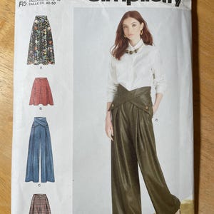 May include: Simplicity sewing pattern S9682 featuring a woman wearing olive green wide-leg pants. The pattern includes options for skirts and pants. The pattern size is U.S. 14-22. The pattern is designed and printed in the USA.