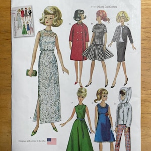 May include: Simplicity sewing pattern S9396 for 29cm doll clothes. The pattern includes designs for doll outfits such as a long dress, a red coat, a checkered dress, a skirt suit, a green dress, a blue dress, and a hooded jacket with plaid trousers. Printed in the USA.