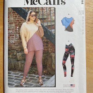 May include: McCall's sewing pattern M8244 featuring multiple view options. The pattern includes a color-blocked hoodie and leggings, and a color-blocked top. The pattern is designed and printed in the USA. Size B5 (8-10-12-14-16).