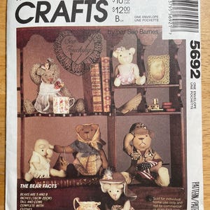 May include: McCall's Crafts pattern featuring a display of handmade teddy bears in various outfits. The bears are 5 to 8 inches (16-20cm) tall and come with clothes. The pattern includes the text "Sew Touching" and "The Bear Facts".