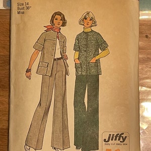 May include: Simplicity sewing pattern number 6529 for a miss, size 14, bust 36 inches. The pattern includes two outfits: a long-sleeved, collared top with a pocket and a pair of wide-legged trousers, and a short-sleeved, collared top with a pocket. The pattern is labelled "Jiffy" and indicates that it is easy to cut and sew. The pattern is for 4 main pieces.
