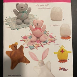 May include: A sewing pattern for making plush toys. The pattern includes instructions for making a bear, a chick, a bunny, and a reversible egg. The pattern is from Simplicity and is designed by Abby Glassenberg.