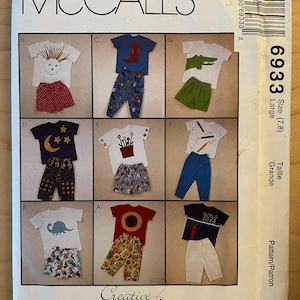 May include: Sewing pattern for children's clothing, McCall's pattern number 6933, size 7/8, large. The pattern includes nine different designs for shirts and trousers with various graphic prints, including a dinosaur, a sunflower, a moon, a crocodile, and a boot.