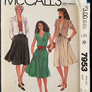 May include: McCall's sewing pattern number 7953 for a dress and jacket. The pattern is for miss sizes 18 to 40. The pattern features a green dress with a V-neck and a white jacket with short sleeves. The pattern is made for you and features bust cup size adjustment darts.