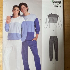 May include: A New Look sewing pattern for knitwear, featuring a color-blocked sweatshirt and sweatpants. The pattern includes a diagram of the clothing and the text "easy just for KNITS". The model is wearing a color-blocked sweatshirt and sweatpants.