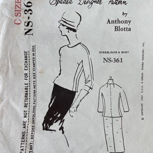 May include: Vintage Spadea Designer Pattern NS-361 for an overblouse and skirt. The illustration shows a two-piece dress design with a long-sleeved top and a knee-length skirt. The pattern includes the text "C SIZE 14" and "NS-361" on the front.