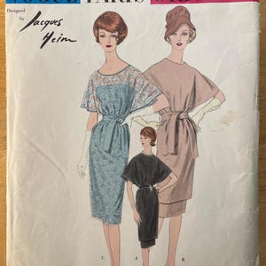 May include: Vintage Vogue Paris Original sewing pattern featuring three dress designs. The pattern cover displays illustrations of the dresses in various colors, with the text "Vogue Paris Original" and "Designed by Jacques Heim". The pattern number is 1493.