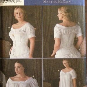May include: A sewing pattern for a white, off-the-shoulder, long-sleeved dress with a lace trim. The pattern is from Simplicity and is called "The Fashion Historian" by Martha McCain. The pattern is for sizes HH 6, 8, 10, and 12. The bust size is 32-38 and the waist size is 34-40.