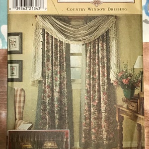 May include: Simplicity Home sewing pattern number 8052 for country window dressing. The pattern shows a floral print curtain with a lace valance and a matching tie-back.