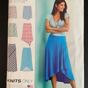 May include: A sewing pattern for a skirt, Simplicity pattern number S0685. The pattern includes five different skirt styles, including a straight skirt, a wrap skirt, a tiered skirt, a high-low skirt, and a maxi skirt. The pattern is for knit fabrics only.