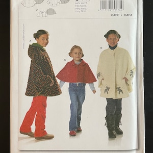 May include: A sewing pattern for a cape, with instructions in English, French, German, and Spanish. The pattern is for sizes 4 to 10 and includes seam and hem allowances. The pattern is illustrated with three children wearing different versions of the cape.