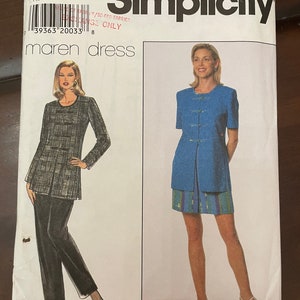 May include: Simplicity sewing pattern number 7527 for a dress, sizes 14, 16, and 18. The pattern includes instructions for a blue dress with short sleeves and a black and white plaid dress with long sleeves.