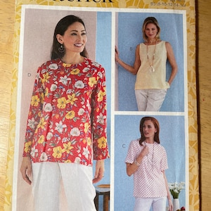 May include: A Butterick B6751 sewing pattern envelope for sizes 8-16. The cover displays three top variations: a long-sleeved red floral print top, a sleeveless yellow textured top, and a short-sleeved white top with small red polka dots.