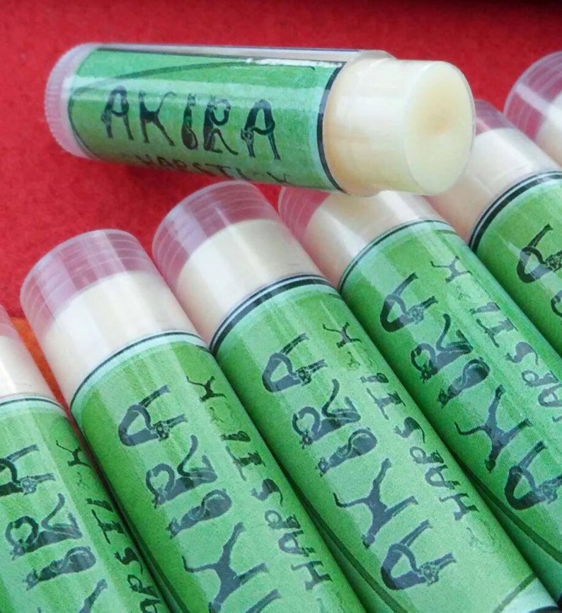 May include: A close-up of several green and white lip balm tubes with the text "Happy Birthday" and "Akira" on the labels.