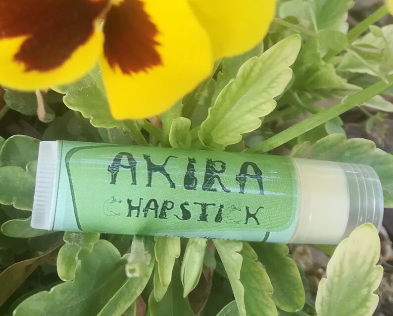 May include: A green and white tube of lip balm with the text "AKIRA CHAPSTICK" on the label.