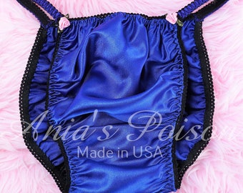 May include: Blue satin underwear with black lace trim and pink rose embellishments. The underwear has adjustable straps and says "Made in USA".