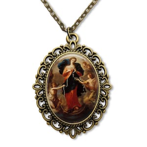 May include: A gold-toned oval pendant necklace with a detailed filigree frame. The pendant features a colorful image of the Virgin Mary, known as Our Lady of the Untied Knots, holding a knotted rope. Two angels are flanking her.